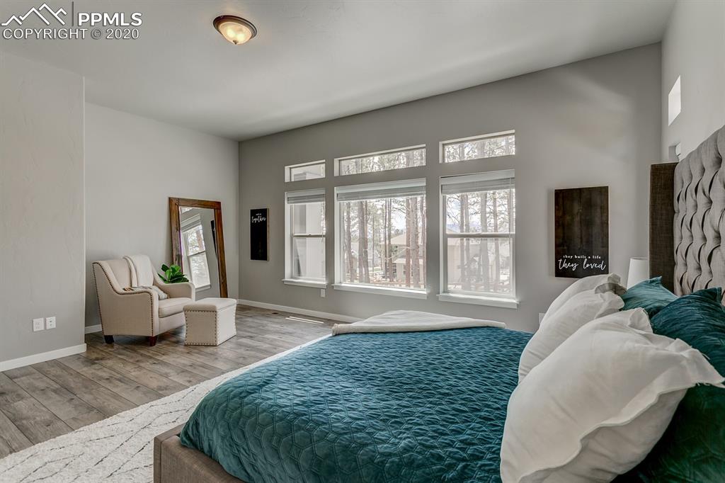 16430 Dancing Bear Lane Monument, CO 80132 - Photo 21 of 50 a spacious bedroom with a large bed and a couch