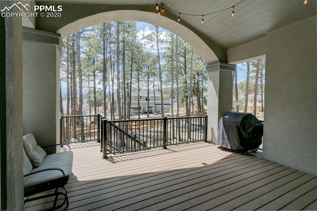 16430 Dancing Bear Lane Monument, CO 80132 - Photo 27 of 50 a bedroom with a bed and wooden floor