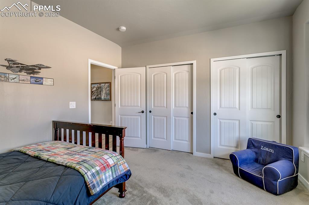 16430 Dancing Bear Lane Monument, CO 80132 - Photo 32 of 50 a bedroom with a bed and a couch