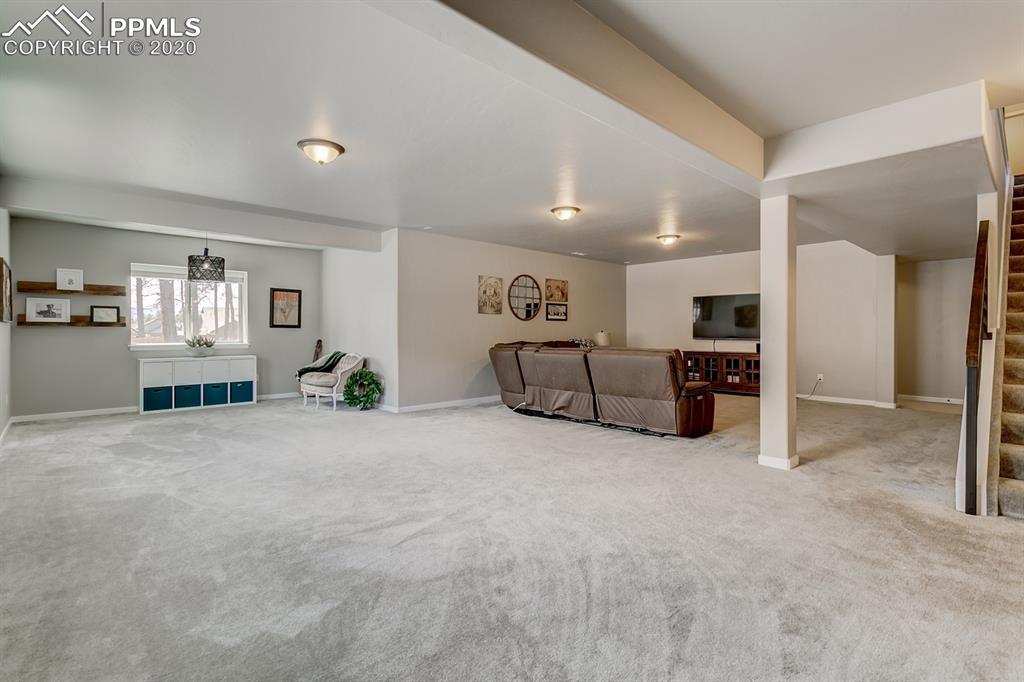 16430 Dancing Bear Lane Monument, CO 80132 - Photo 36 of 50 a large bedroom with furniture and natural light