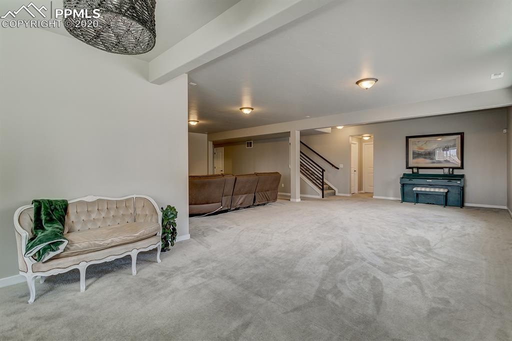 16430 Dancing Bear Lane Monument, CO 80132 - Photo 37 of 50 a living room with furniture and a flat screen tv