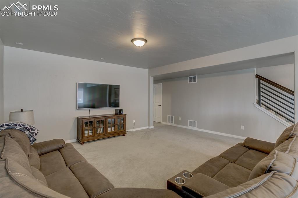 16430 Dancing Bear Lane Monument, CO 80132 - Photo 38 of 50 a living room with furniture and a flat screen tv