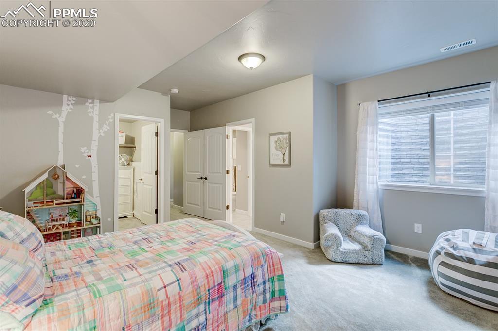 16430 Dancing Bear Lane Monument, CO 80132 - Photo 40 of 50 a bedroom with a bed and a window