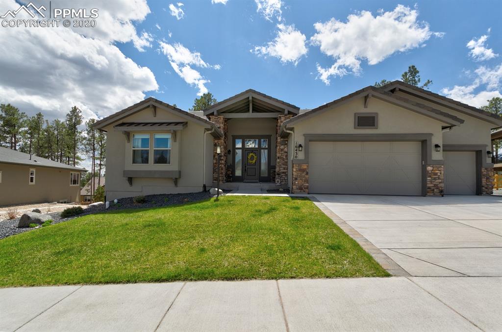 16430 Dancing Bear Lane Monument, CO 80132 - Photo 4 of 50 a front view of a house with a garden and yard