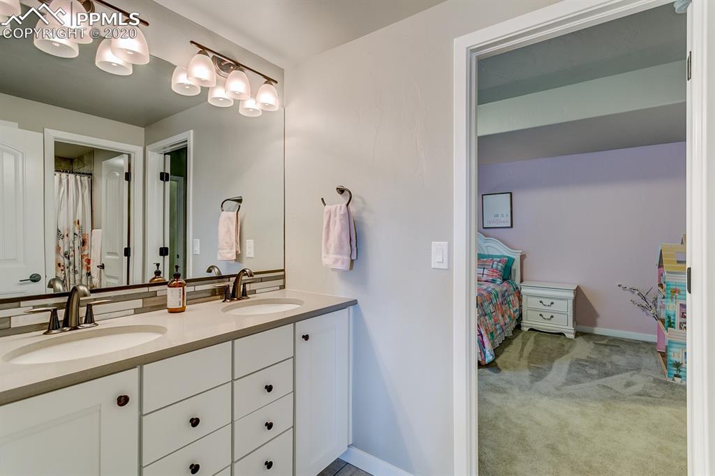 16430 Dancing Bear Lane Monument, CO 80132 - Photo 43 of 50 a bathroom with a sink vanity and a mirror