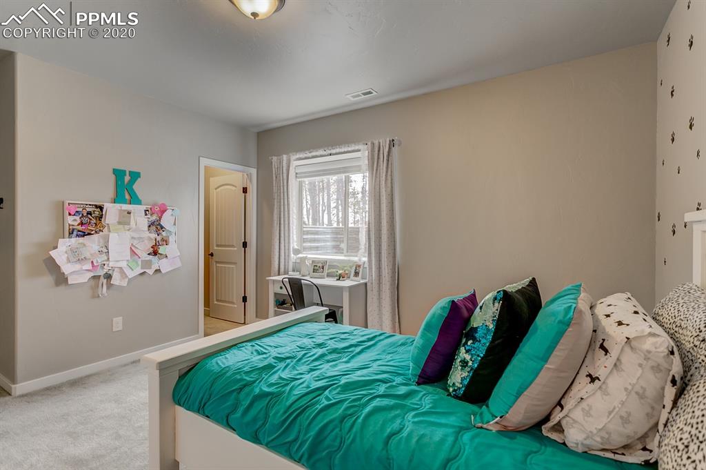 16430 Dancing Bear Lane Monument, CO 80132 - Photo 44 of 50 a bedroom with a bed and a window