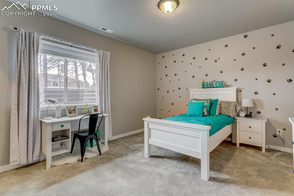 16430 Dancing Bear Lane Monument, CO 80132 - Photo 45 of 50 a bedroom with a bed and a table