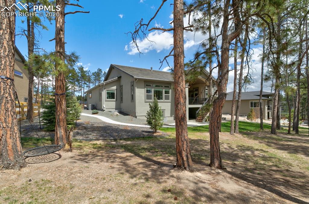 16430 Dancing Bear Lane Monument, CO 80132 - Photo 49 of 50 a view of a house with backyard and tree