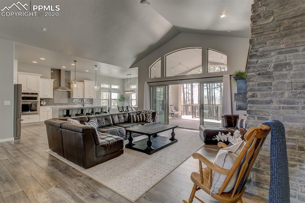 16430 Dancing Bear Lane Monument, CO 80132 - Photo 6 of 50 a living room with furniture wooden floor and a large window