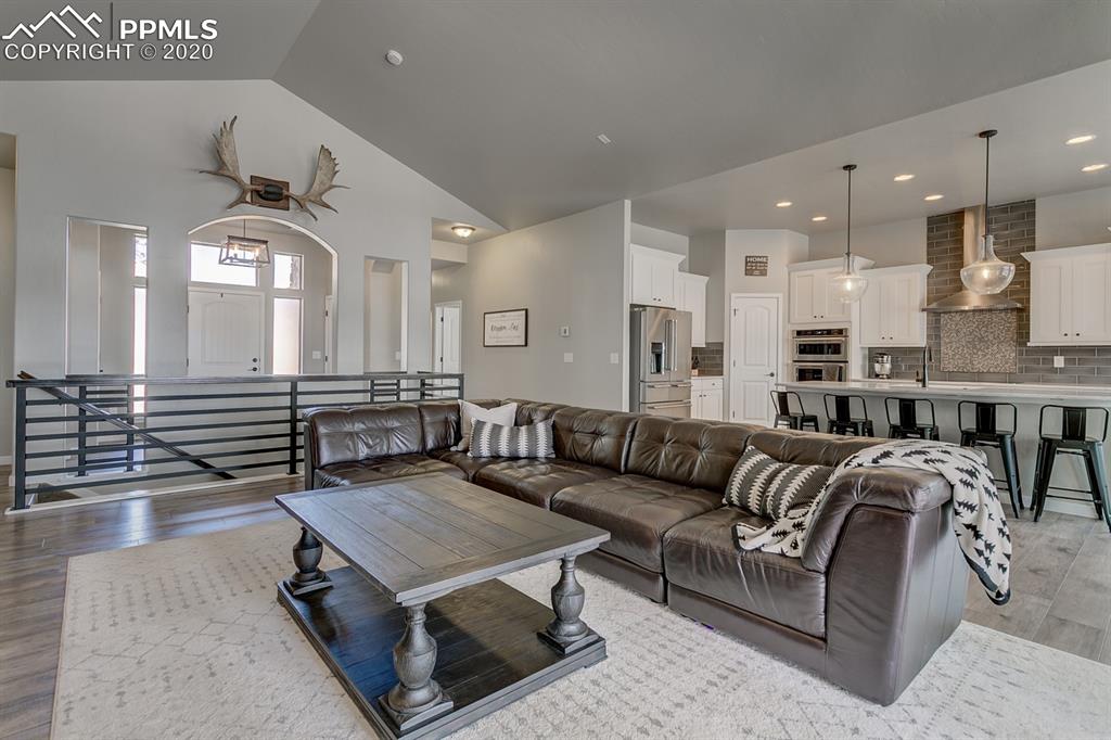 16430 Dancing Bear Lane Monument, CO 80132 - Photo 10 of 50 a living room with furniture kitchen view and a chandelier