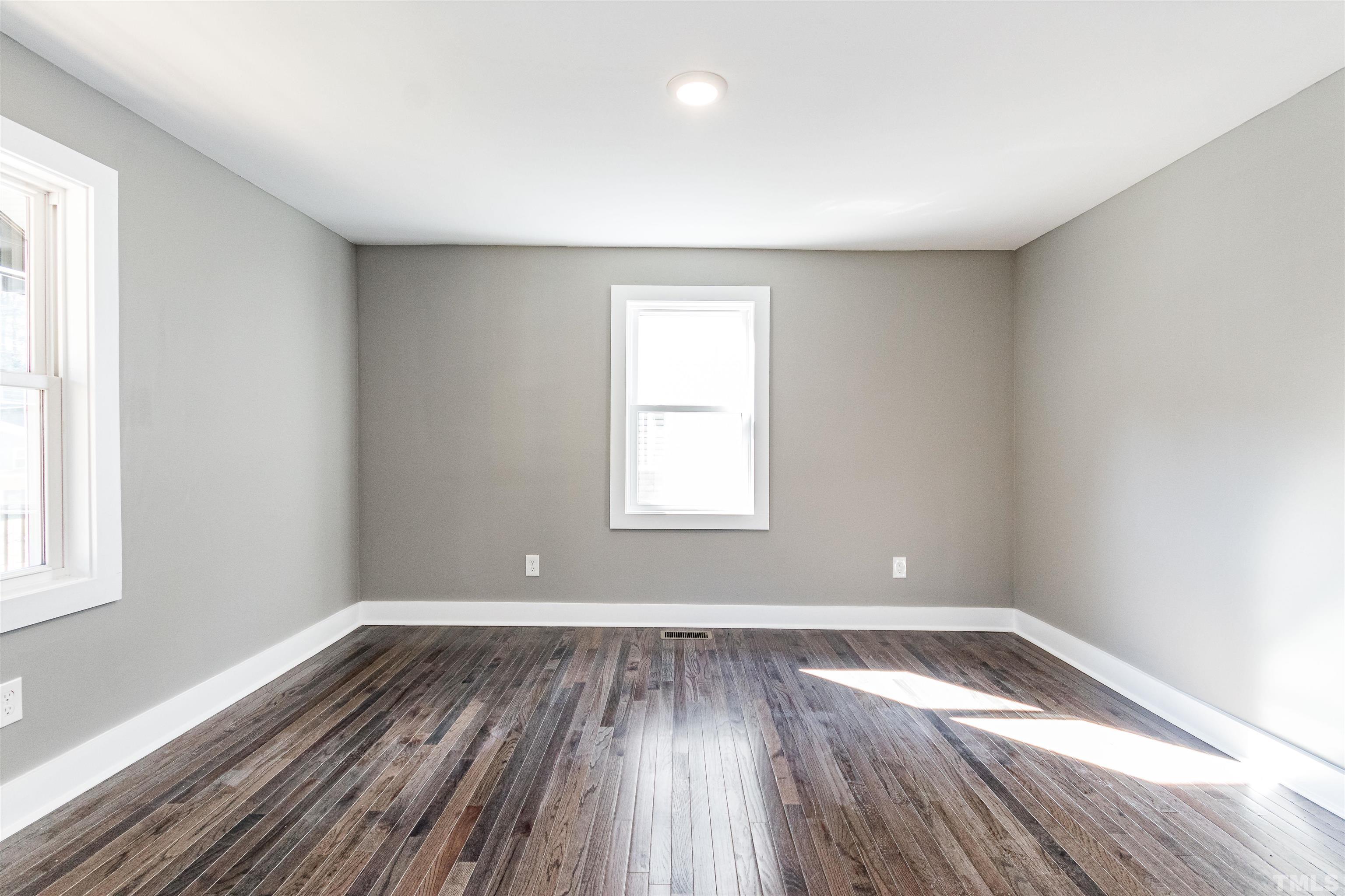 824 Coleman Street Raleigh, NC 27610 - Photo 14 of 30 an empty room with wooden floor and windows
