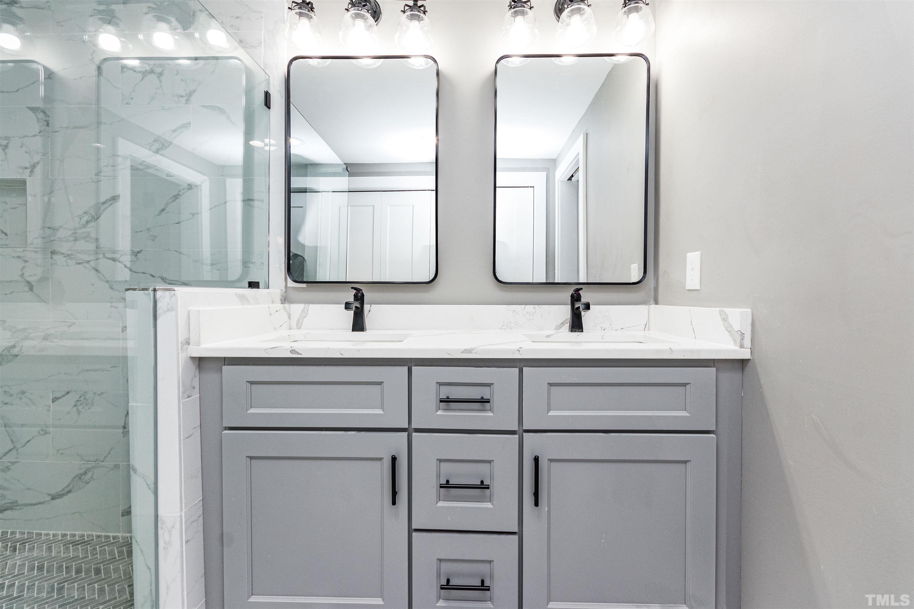 824 Coleman Street Raleigh, NC 27610 - Photo 22 of 30 a bathroom with a double vanity sink and mirror
