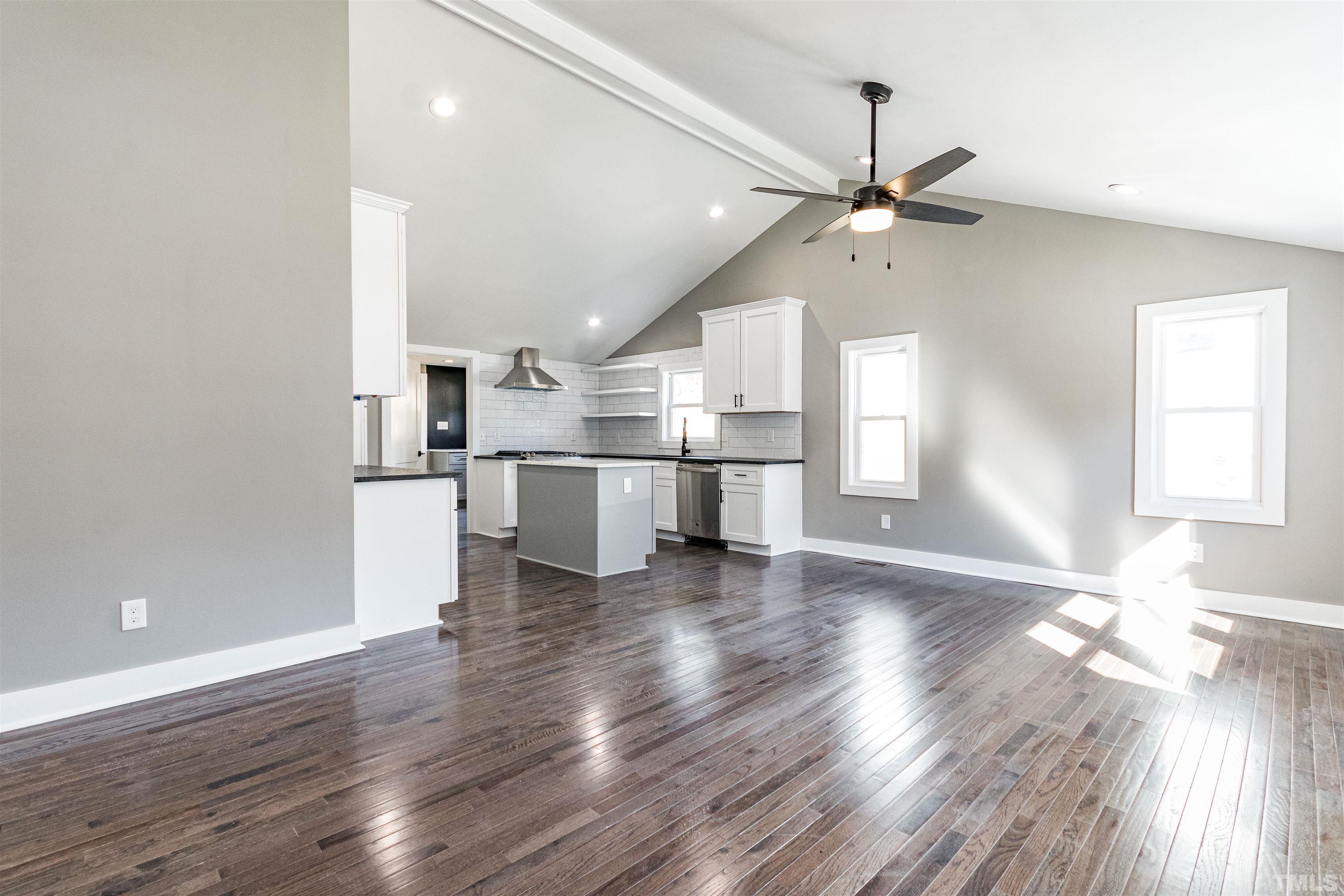 824 Coleman Street Raleigh, NC 27610 - Photo 4 of 30 a view of a kitchen with a fridge wooden floor and a kitchen
