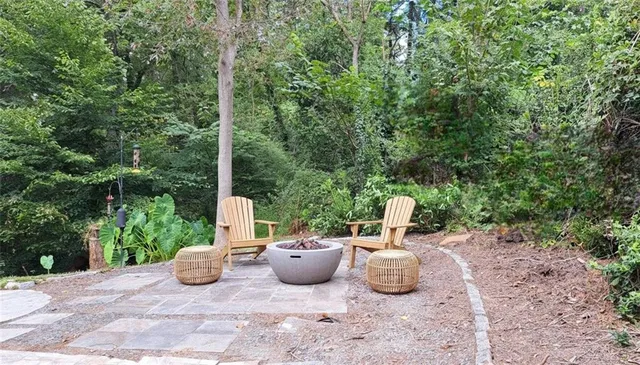 a view of a patio with table and chairs and potted plants