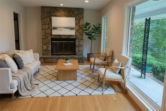 a living room with furniture a flat screen tv and a fireplace