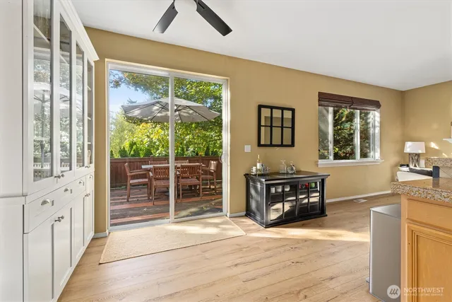 a living room with wooden floor and a flat screen tv