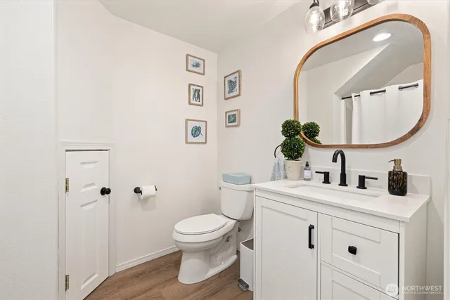 a bathroom with a sink a toilet and a mirror