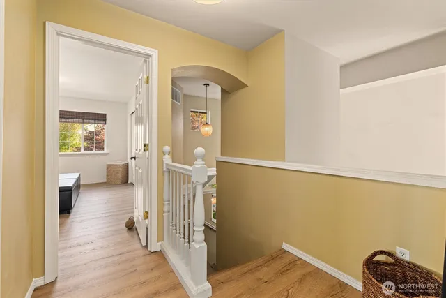 a view of a livingroom with wooden floor and a bathroom