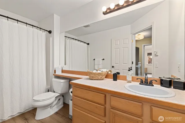 a bathroom with a toilet a sink and a mirror