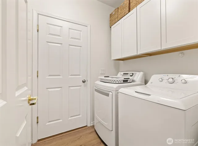 a view of storage and utility room with washer and dryer