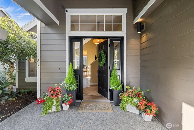 a vase of flowers sitting in front of a door