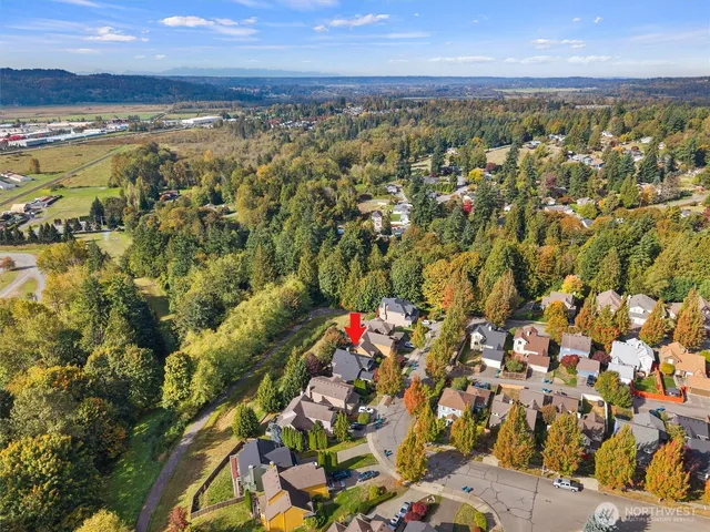an aerial view of a house with a yard and garden