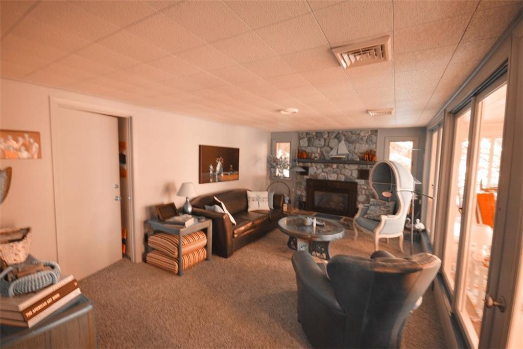 711 Anderson Road Sebago, ME 04029 - Photo 12 of 17 Comfortable living room with wall of...