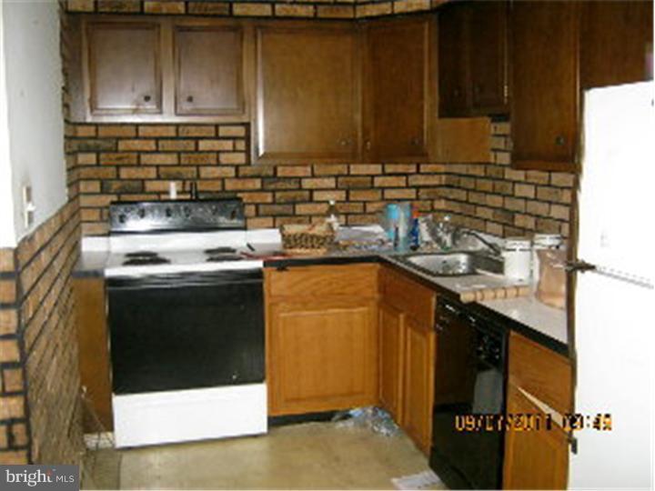 1318 Rainer Road Brookhaven, PA 19015 - Photo 5 of 13 a kitchen with a sink a stove and cabinets