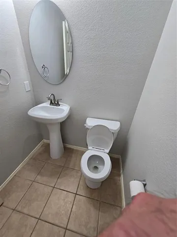 a bathroom with a sink toilet and a mirror