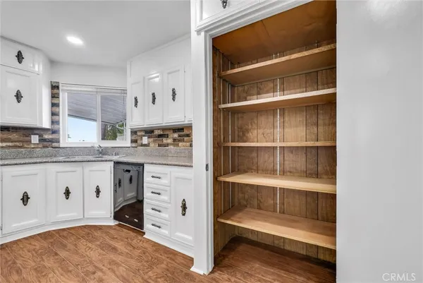 a kitchen with a refrigerator and white cabinets
