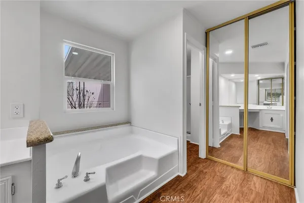 a bathroom with a tub shower and sink