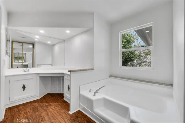 a bathroom with a bathtub and a sink
