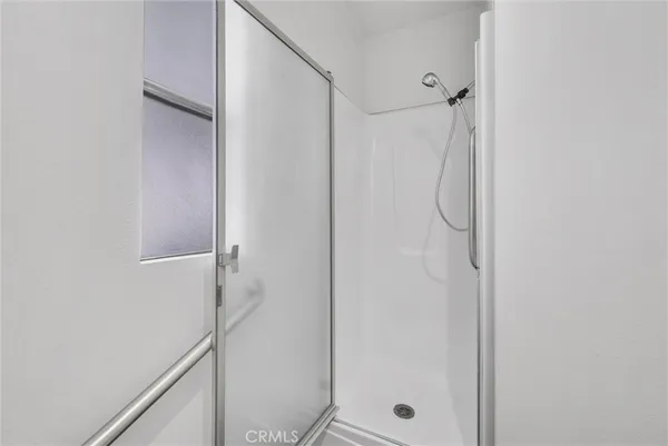 a bathroom with a glass shower door