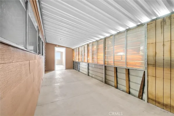 a view of a porch with furniture and floor to ceiling window