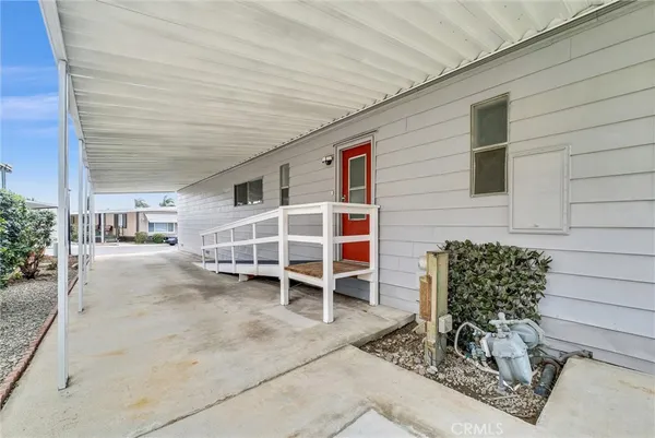 a view of a patio with table and chairs and wooden fence