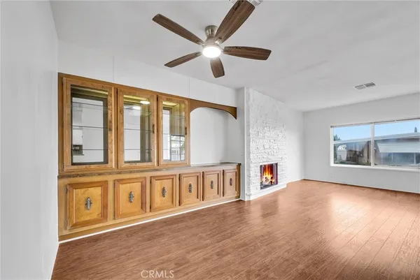 a living room with furniture and a ceiling fan