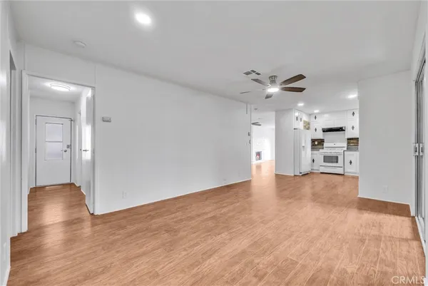 a view of kitchen and hall with wooden floor