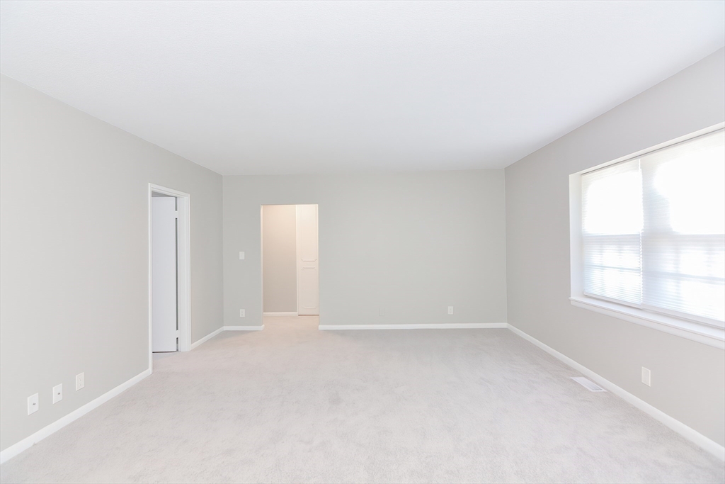 149 Lake Shore Road, Unit 2 Boston, MA 02135 - Photo 11 of 38 an empty room with windows