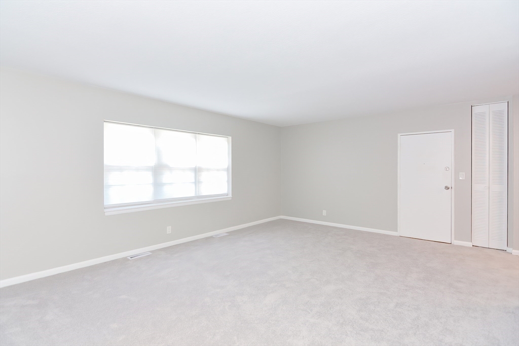 149 Lake Shore Road, Unit 2 Boston, MA 02135 - Photo 13 of 38 an empty room with a window