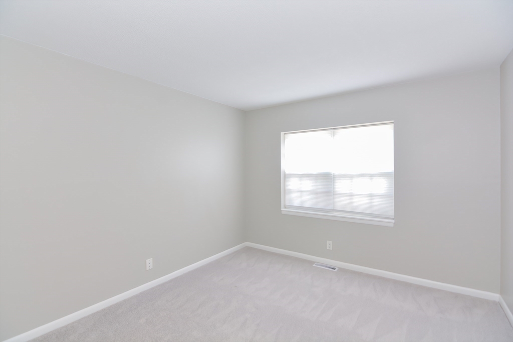 149 Lake Shore Road, Unit 2 Boston, MA 02135 - Photo 16 of 38 an empty room with a window