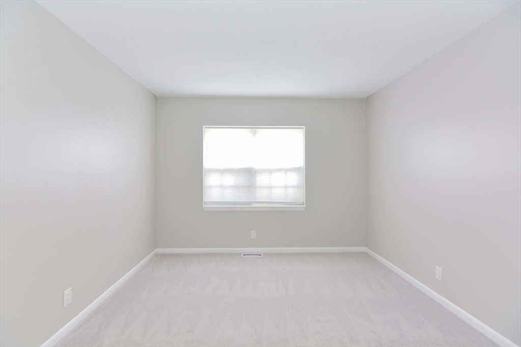 149 Lake Shore Road, Unit 2 Boston, MA 02135 - Photo 17 of 38 an empty room with a window