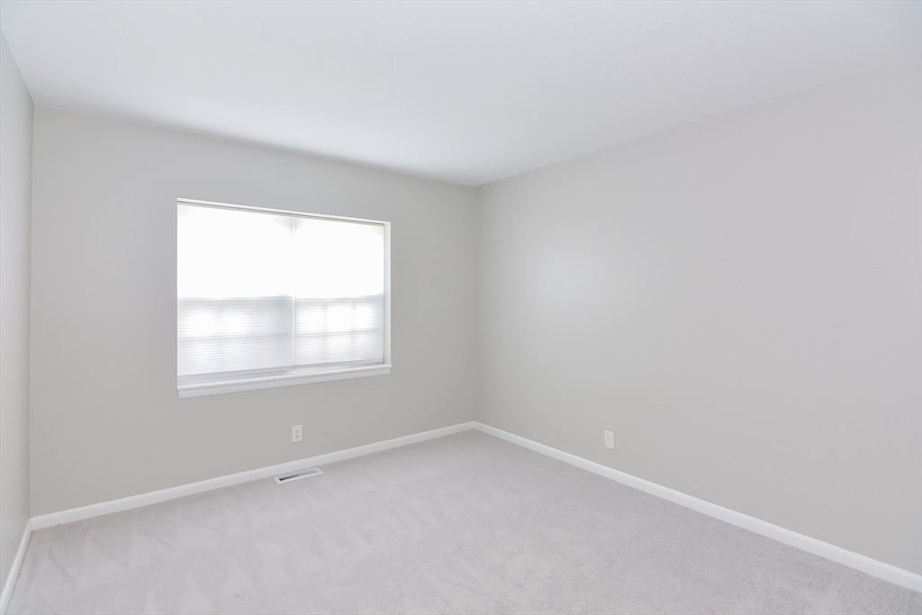 149 Lake Shore Road, Unit 2 Boston, MA 02135 - Photo 18 of 38 an empty room with a window
