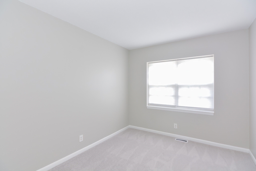 149 Lake Shore Road, Unit 2 Boston, MA 02135 - Photo 19 of 38 an empty room with a window