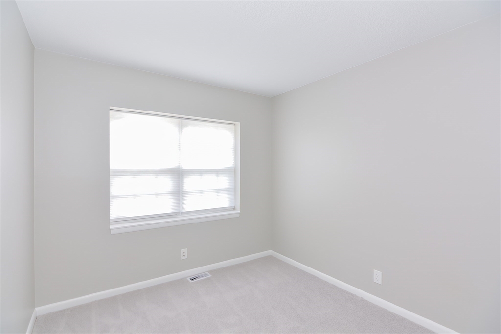 149 Lake Shore Road, Unit 2 Boston, MA 02135 - Photo 20 of 38 an empty room with a window