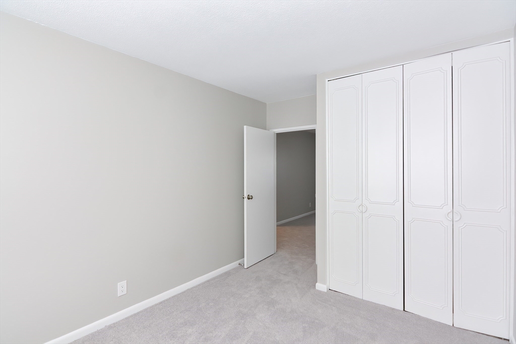 149 Lake Shore Road, Unit 2 Boston, MA 02135 - Photo 22 of 38 a view of an empty room