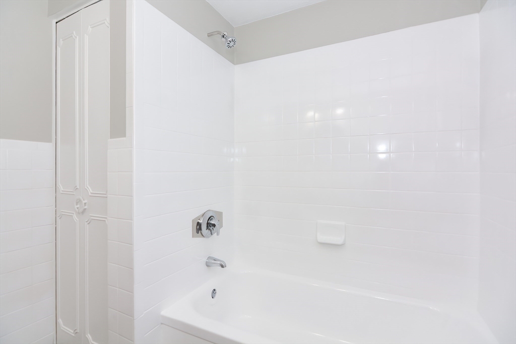 149 Lake Shore Road, Unit 2 Boston, MA 02135 - Photo 25 of 38 a bathroom with a bathtub