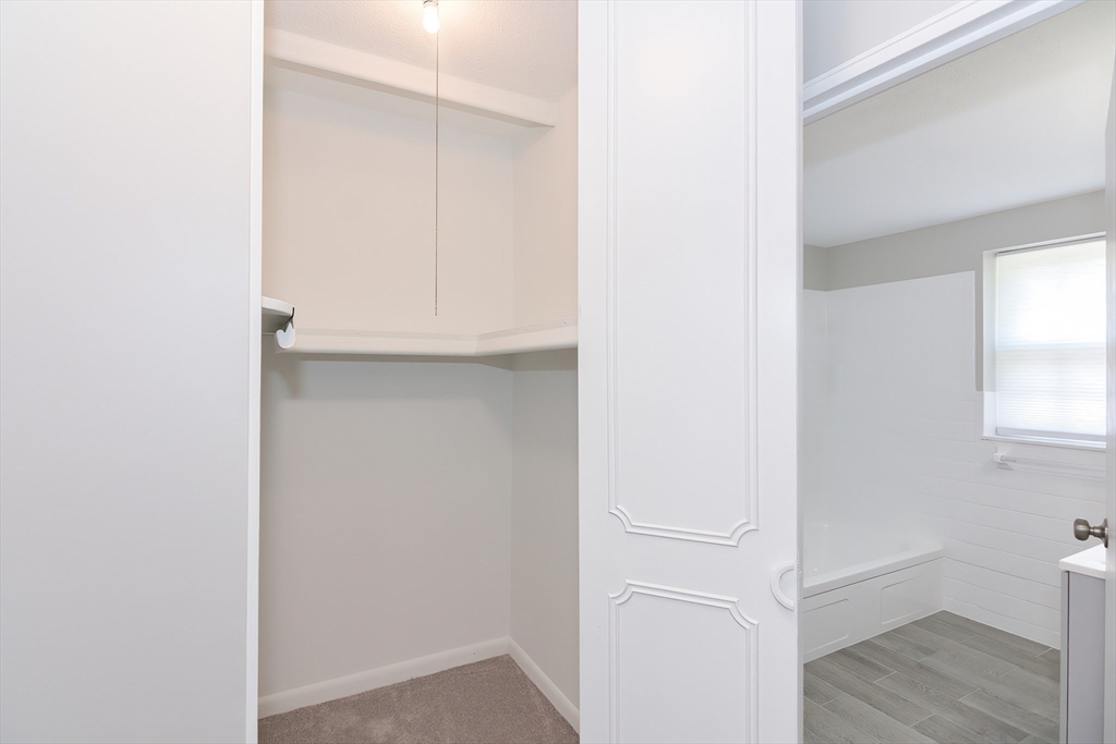 149 Lake Shore Road, Unit 2 Boston, MA 02135 - Photo 26 of 38 a view of an empty room with wooden floor and a window