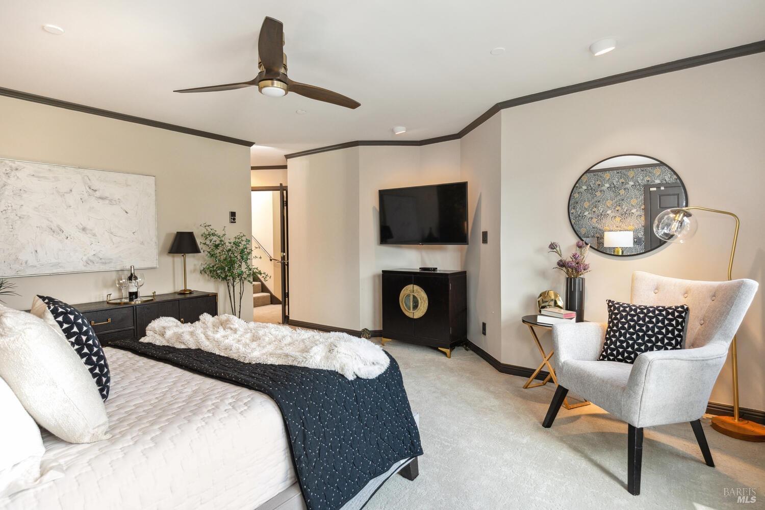 31 Edwards Avenue Sausalito, CA 94965 - Photo 25 of 51 a bedroom with a bed a chair and a chandelier