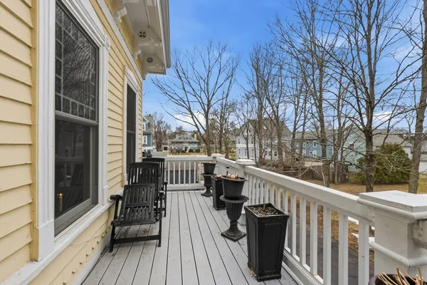 a view of a balcony with wooden floor and fence