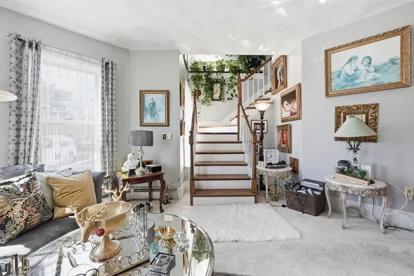 a living room with furniture and a painting